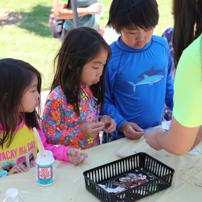 Sunkist Branch image of child crafting with paints during an art program hosted outdoors