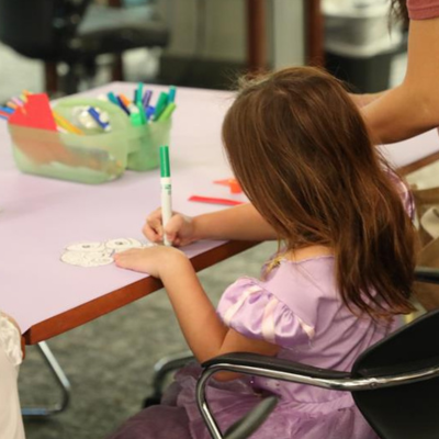 East Anaheim Branch - Image of a Frozen Elsa and Ana posing with two children