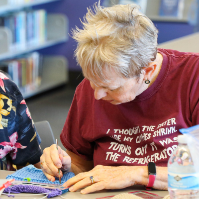 Image of a women working on a crochet project