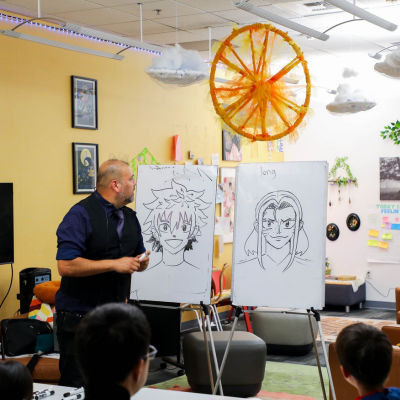 Image of artist Carlos drawing