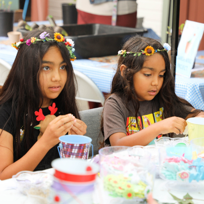 Image of the two girls with floral crowns.